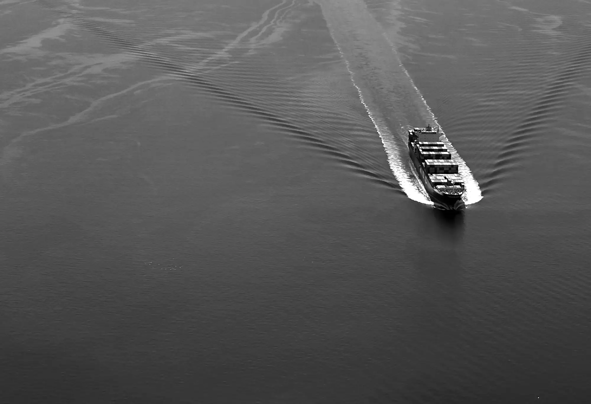 Aerial view of a container ship crossing open water